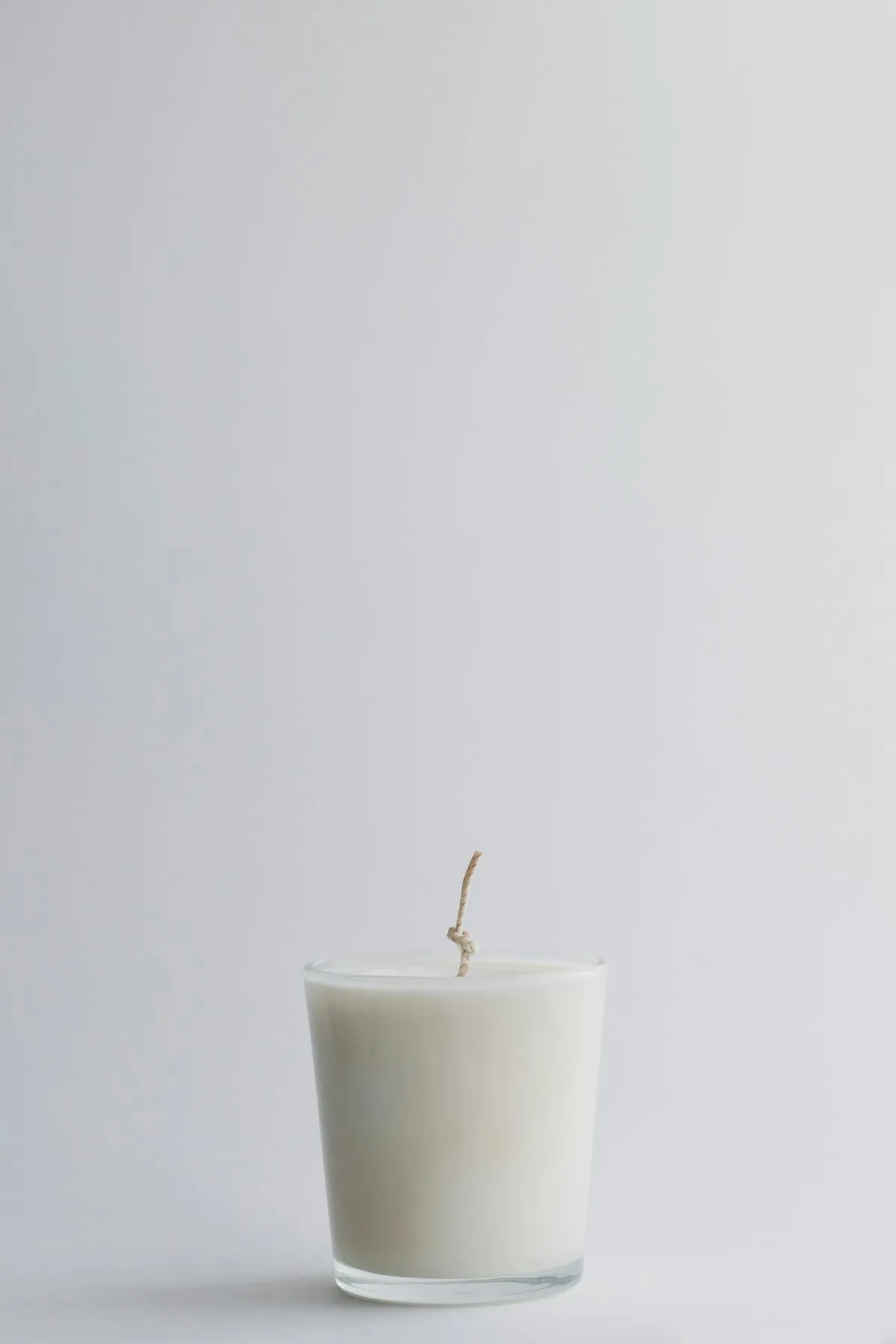 Lit candle in a warm home interior setting